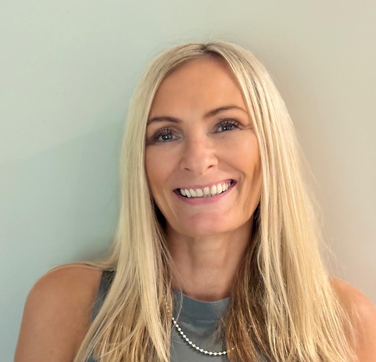 Emma, founder of MFO Coaching, smiling in close-up portrait headshot
